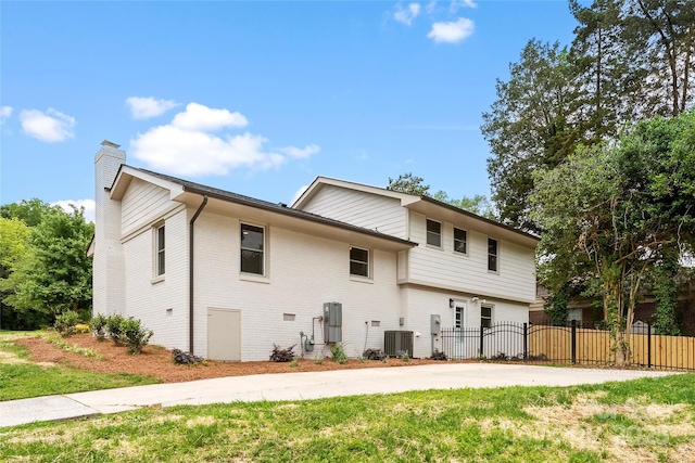 3661 Annlin Ave, Charlotte, NC 28209 - view of property exterior with a chimney, central air condition unit, brick siding, and concrete driveway