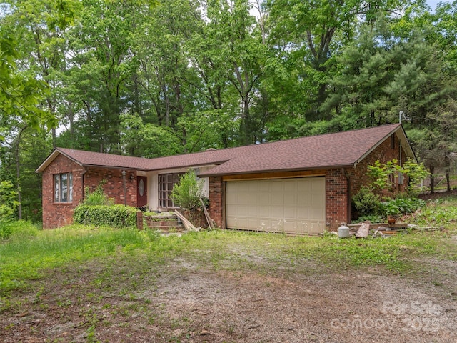 3 N Marley Dr, Flat Rock, NC 28731 - view of front of home with dirt driveway, an attached garage, and brick siding