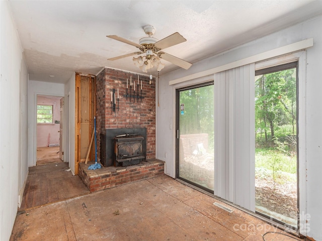 3 N Marley Dr, Flat Rock, NC 28731 - unfurnished living room featuring a wood stove and ceiling fan