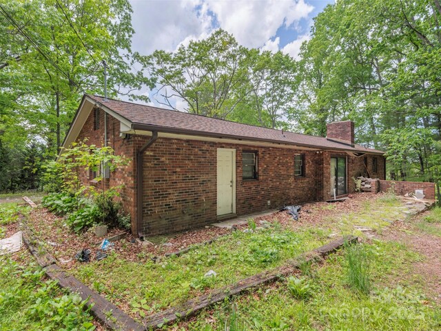 3 N Marley Dr, Flat Rock, NC 28731 - rear view of house with a chimney and brick siding
