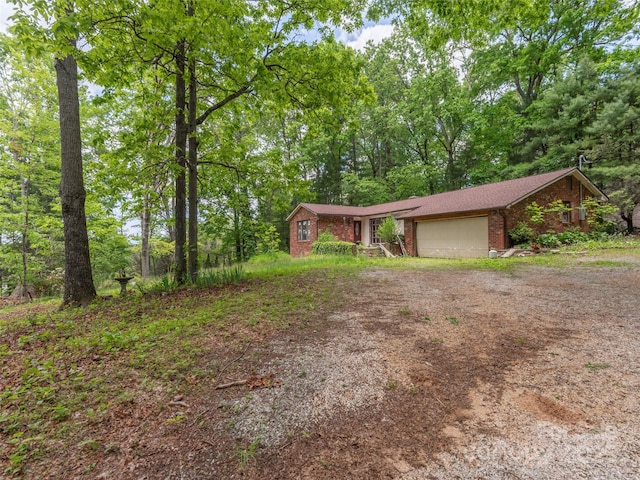 3 N Marley Dr, Flat Rock, NC 28731 - view of front facade featuring brick siding, driveway, and an attached garage
