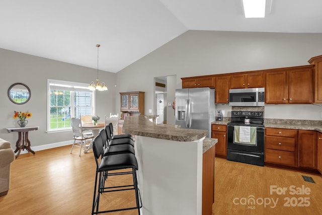 170 Wagon Wheel Way Unit 4, Salisbury, NC 28147 - kitchen with appliances with stainless steel finishes, light wood-style flooring, high vaulted ceiling, and brown cabinets