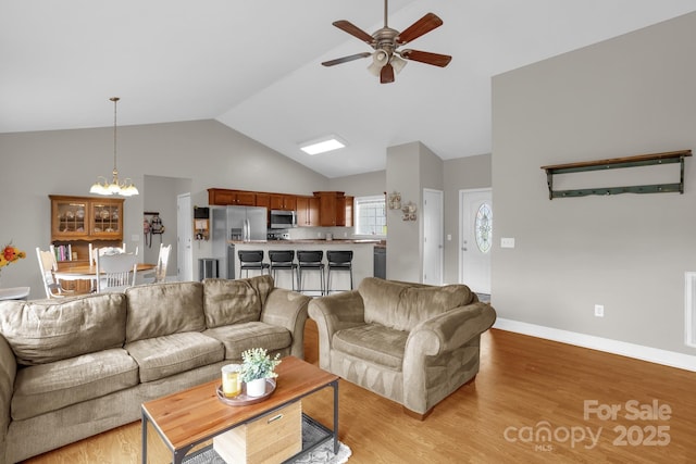 170 Wagon Wheel Way Unit 4, Salisbury, NC 28147 - living room with a chandelier, ceiling fan, light wood-style flooring, baseboards, and high vaulted ceiling