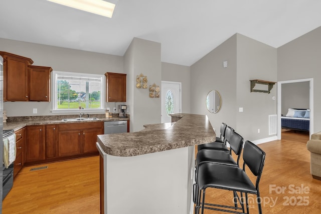 170 Wagon Wheel Way Unit 4, Salisbury, NC 28147 - kitchen featuring a sink, light wood finished floors, dishwasher, a breakfast bar area, and black range with electric stovetop