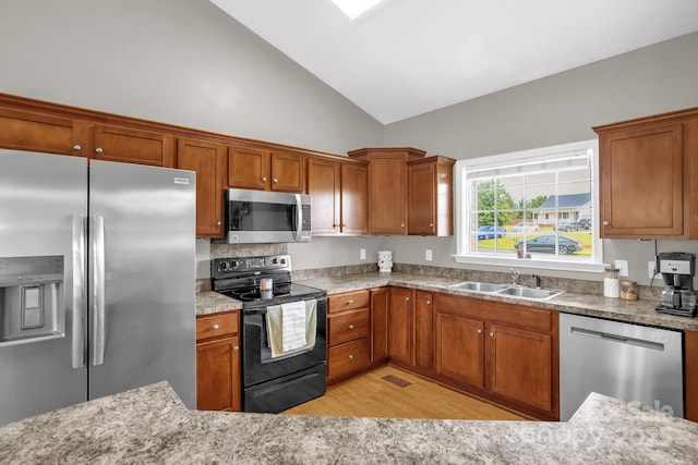 170 Wagon Wheel Way Unit 4, Salisbury, NC 28147 - kitchen with stainless steel appliances, a sink, light wood-type flooring, brown cabinetry, and high vaulted ceiling
