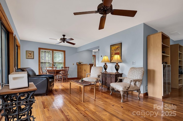 214 Laurel Mountain Trl, Saluda, NC 28773 - living room featuring ceiling fan, light wood-style floors, and baseboards