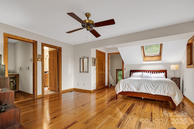 214 Laurel Mountain Trl, Saluda, NC 28773 - bedroom featuring light wood-style floors, a skylight, baseboards, and a ceiling fan