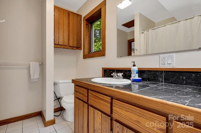 214 Laurel Mountain Trl, Saluda, NC 28773 - bathroom featuring toilet, vanity, tile patterned floors, and baseboards