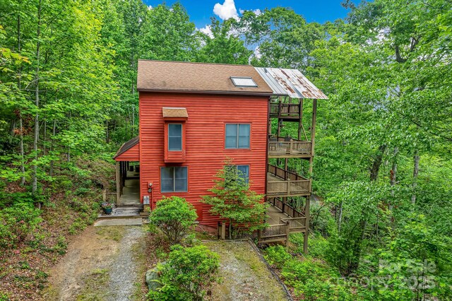 214 Laurel Mountain Trl, Saluda, NC 28773 - rustic home featuring a balcony and driveway