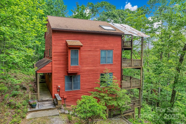 214 Laurel Mountain Trl, Saluda, NC 28773 - view of front of house featuring roof with shingles and a balcony