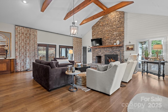 140 Lost Trl Unit 145, Highlands, NC 28741 - living area featuring high vaulted ceiling, plenty of natural light, beamed ceiling, wood finished floors, and a stone fireplace