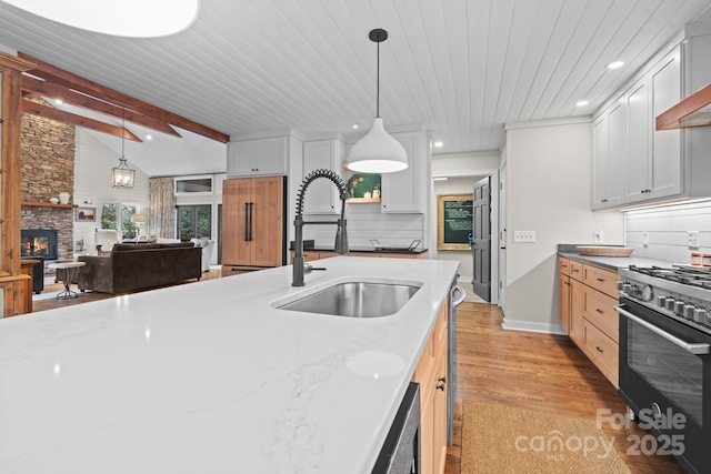 140 Lost Trl Unit 145, Highlands, NC 28741 - kitchen with a sink, gas range, light wood-type flooring, a fireplace, and wood ceiling