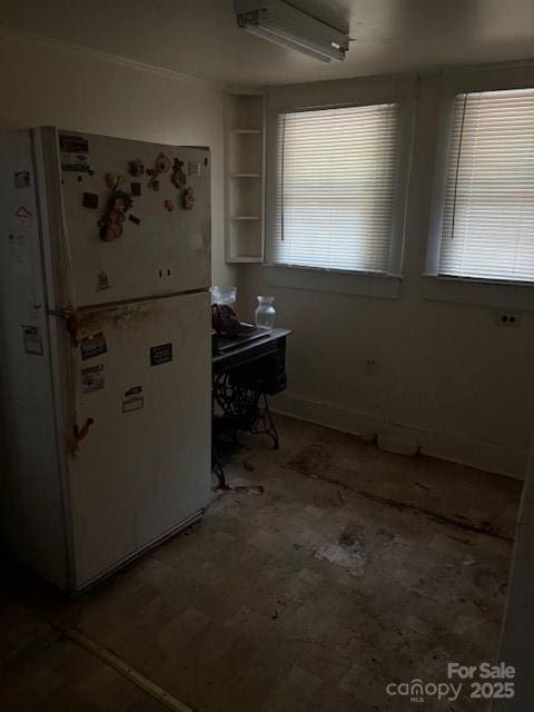 kitchen featuring freestanding refrigerator