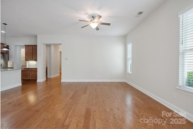 467 Granite Lake Ct, Denver, NC 28037 - unfurnished living room with ceiling fan, light wood-style floors, and baseboards