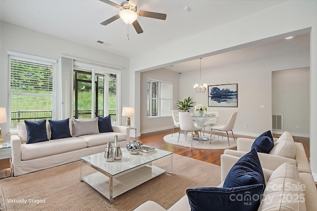 467 Granite Lake Ct, Denver, NC 28037 - living area featuring wood finished floors, a chandelier, healthy amount of natural light, and a ceiling fan