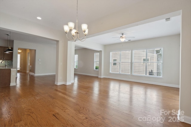 467 Granite Lake Ct, Denver, NC 28037 - empty room featuring wood finished floors, ceiling fan, a chandelier, baseboards, and recessed lighting