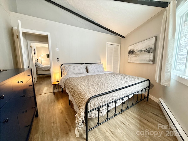 109 Beechwood Ln, Beech Mountain, NC 28604 - bedroom with baseboard heating, lofted ceiling, light wood-type flooring, a closet, and baseboards