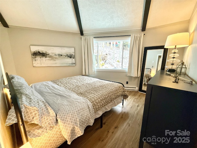 109 Beechwood Ln, Beech Mountain, NC 28604 - bedroom featuring wood finished floors, a baseboard heating unit, a textured ceiling, and baseboards