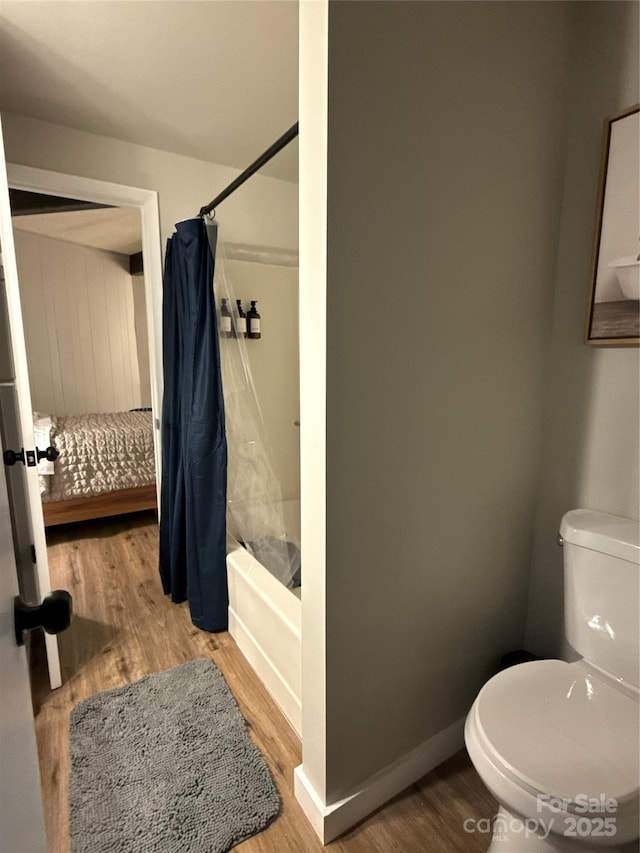 109 Beechwood Ln, Beech Mountain, NC 28604 - ensuite bathroom with shower / bathtub combination with curtain and wood finished floors