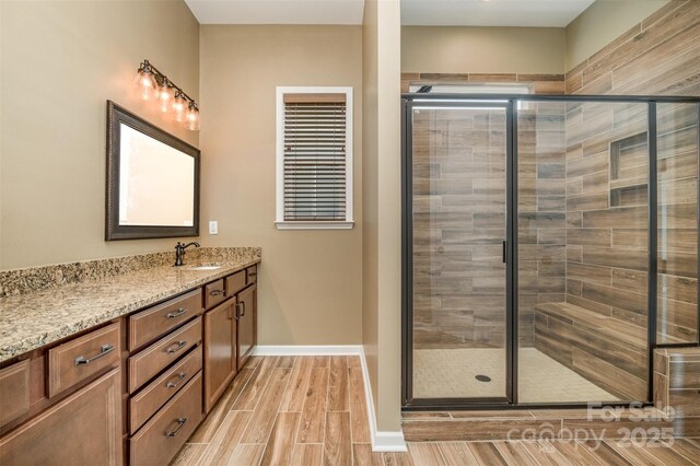 3105 Bonterra Blvd, Indian Trail, NC 28079 - full bathroom with vanity, a stall shower, wood tiled floors, and baseboards