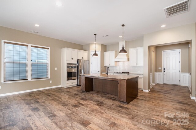 3105 Bonterra Blvd, Indian Trail, NC 28079 - kitchen with appliances with stainless steel finishes, dark wood-style flooring, backsplash, a center island with sink, and recessed lighting