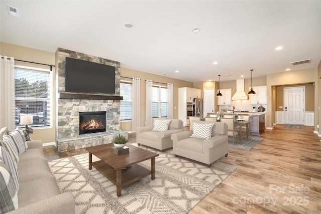 3105 Bonterra Blvd, Indian Trail, NC 28079 - living area with a fireplace, light wood finished floors, baseboards, and recessed lighting