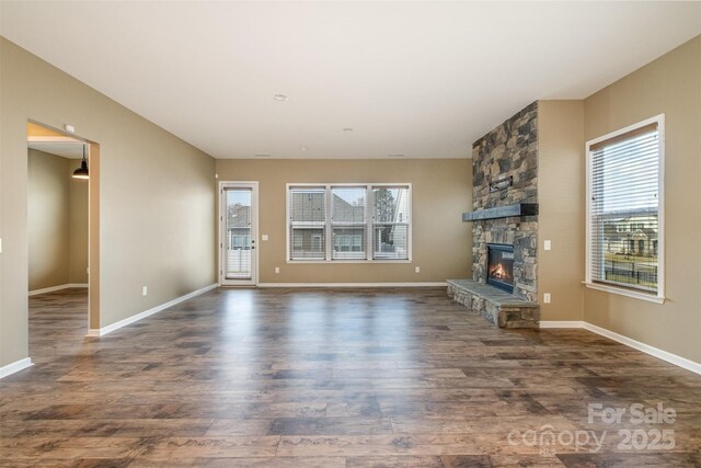 3105 Bonterra Blvd, Indian Trail, NC 28079 - unfurnished living room with plenty of natural light, wood finished floors, a fireplace, and baseboards