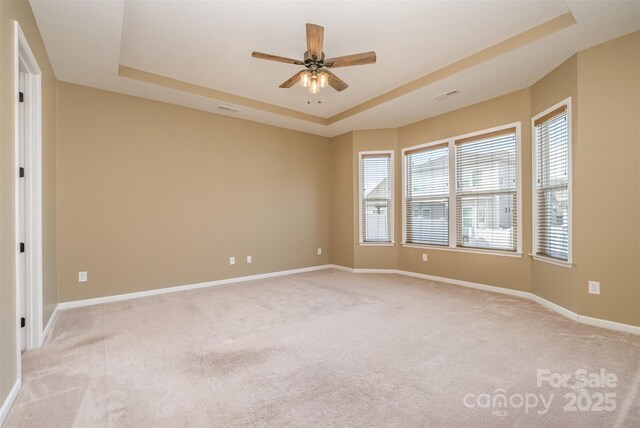 3105 Bonterra Blvd, Indian Trail, NC 28079 - unfurnished room with a raised ceiling, light colored carpet, a ceiling fan, and baseboards