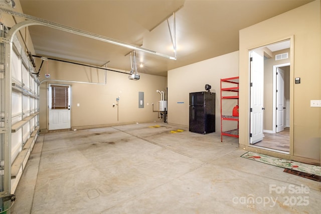 3105 Bonterra Blvd, Indian Trail, NC 28079 - garage with electric panel, a garage door opener, water heater, and freestanding refrigerator