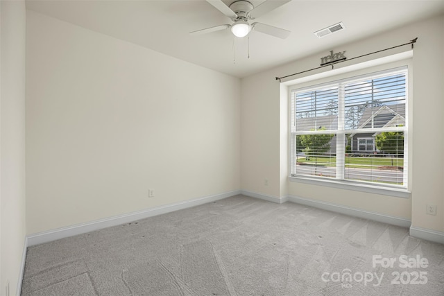 unfurnished room featuring light colored carpet, baseboards, and ceiling fan