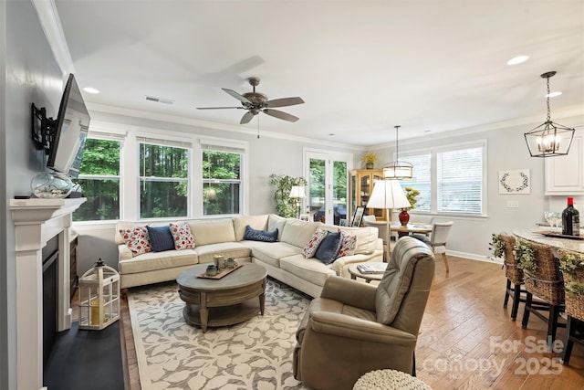 528 Sandbar Pt, Clover, SC 29710 - living area with ornamental molding, baseboards, a ceiling fan, a chandelier, and light wood finished floors