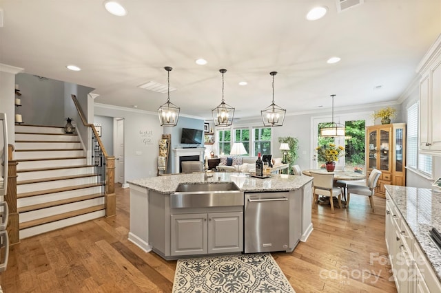 528 Sandbar Pt, Clover, SC 29710 - kitchen with dishwasher, recessed lighting, a fireplace, light wood-type flooring, and a center island with sink