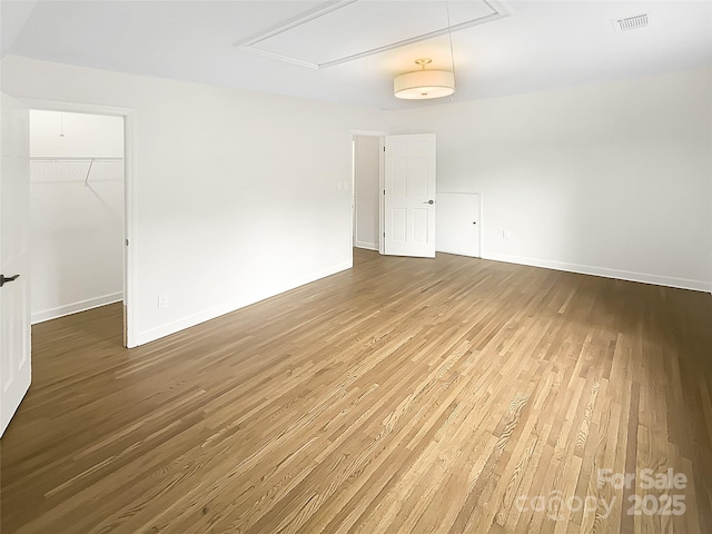 1212 Beechdale Dr, Charlotte, NC 28212 - empty room featuring attic access, wood finished floors, and baseboards