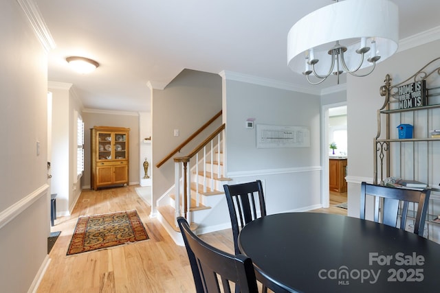 211 Southfork Dr, Belmont, NC 28012 - dining area featuring light wood-style flooring, stairs, crown molding, a chandelier, and baseboards