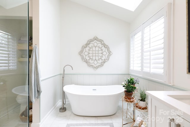 211 Southfork Dr, Belmont, NC 28012 - bathroom with vanity, a freestanding bath, a wainscoted wall, toilet, and vaulted ceiling