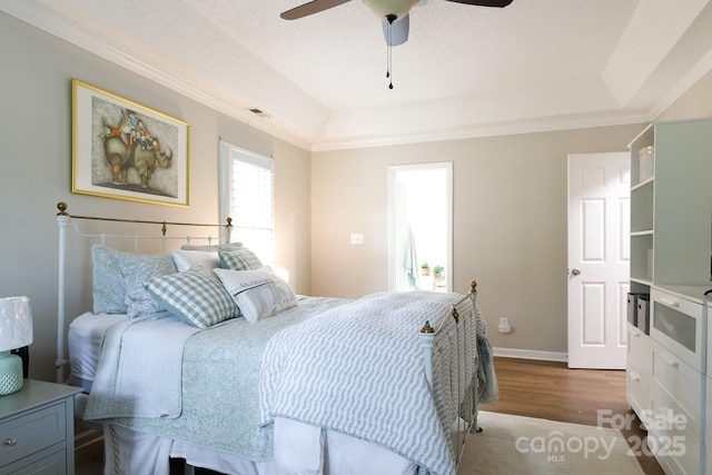 211 Southfork Dr, Belmont, NC 28012 - bedroom featuring wood finished floors, a tray ceiling, crown molding, a ceiling fan, and baseboards