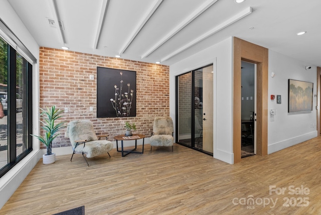 55 S Market St Unit 311, Asheville, NC 28801 - living area with wood finished floors, brick wall, baseboards, and recessed lighting