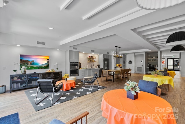 55 S Market St Unit 311, Asheville, NC 28801 - living room with light wood finished floors and a chandelier