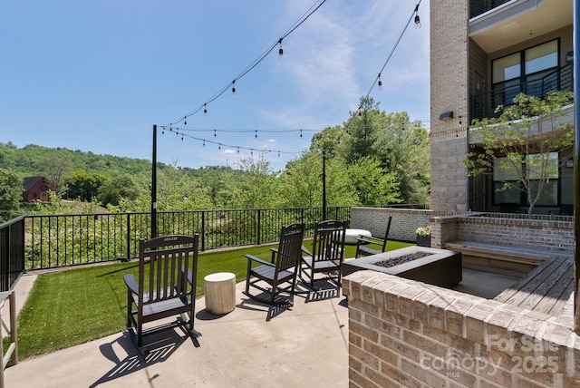 55 S Market St Unit 311, Asheville, NC 28801 - view of patio / terrace featuring a fire pit and a forest view