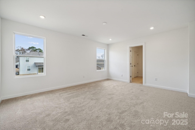carpeted empty room with baseboards and recessed lighting