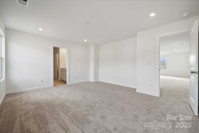 spare room featuring light colored carpet, baseboards, a smoke detector, and recessed lighting