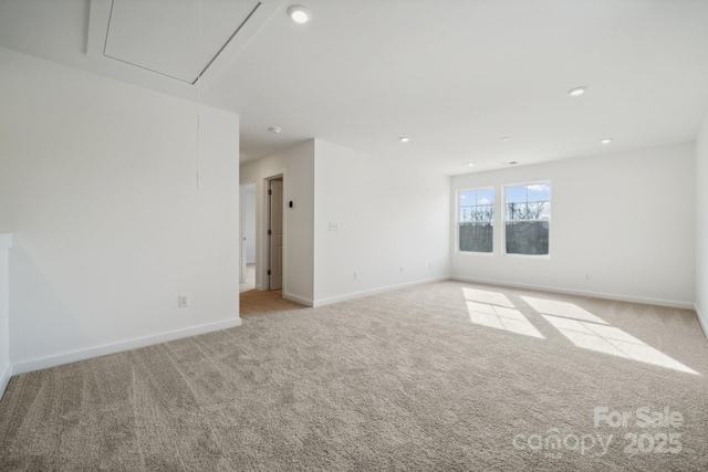 spare room with attic access, light carpet, baseboards, and recessed lighting
