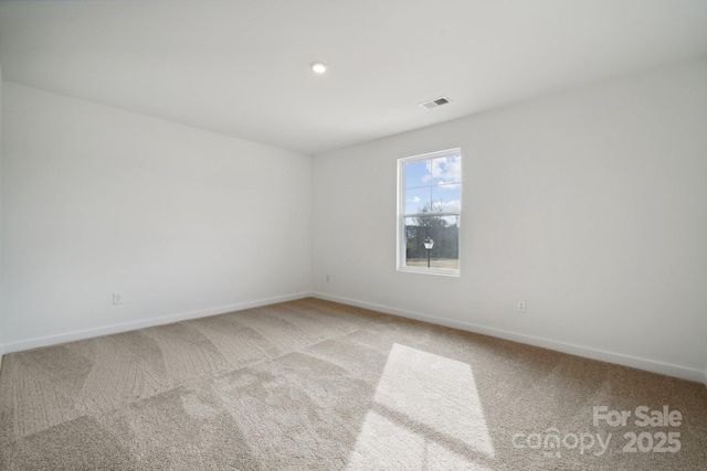carpeted spare room with baseboards