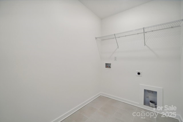 clothes washing area with baseboards, hookup for an electric dryer, and hookup for a washing machine