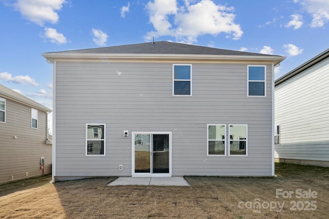 rear view of property featuring a patio and a yard