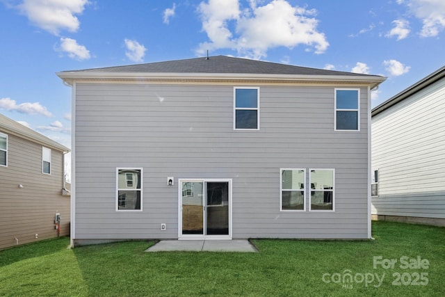 rear view of house with a lawn and a patio area