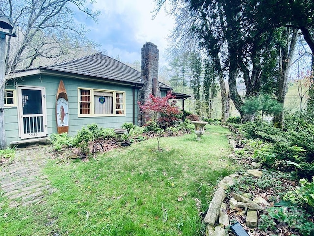 5933 N Norton Rd, Cullowhee, NC 28723 - view of home's exterior featuring a chimney and a lawn