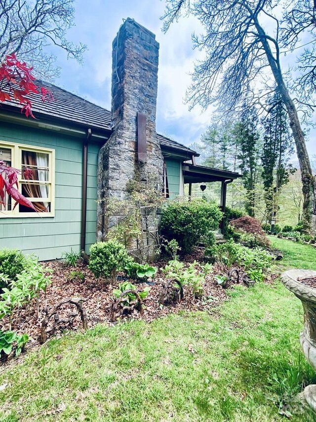 5933 N Norton Rd, Cullowhee, NC 28723 - view of property exterior featuring a chimney and a lawn