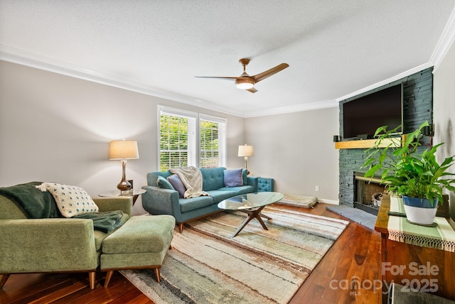 84 Varnadore Dr, Arden, NC 28704 - living room with ornamental molding, wood finished floors, ceiling fan, a fireplace, and a textured ceiling