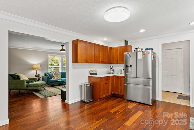 84 Varnadore Dr, Arden, NC 28704 - kitchen featuring stainless steel fridge with ice dispenser, crown molding, light countertops, dark wood-type flooring, and open floor plan